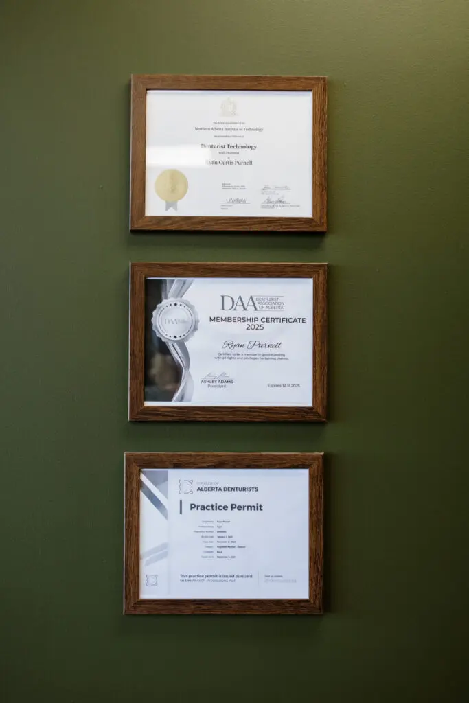 Medicine Hat AB Denture Clinic - Certificates framed on wall
