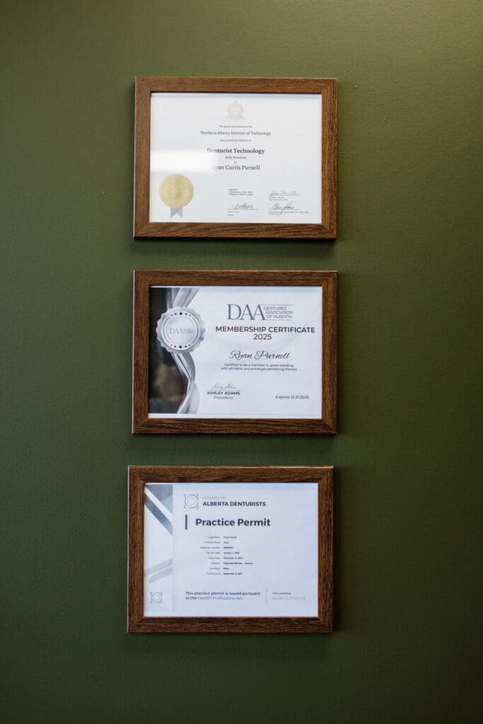 Medicine Hat AB Denture Clinic - Certificates framed on wall