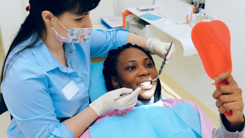 Patient receiving dental checkup from dentist