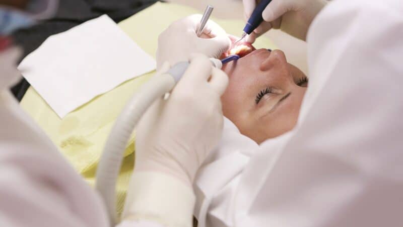 Professional reviewing before and after dental photography on camera