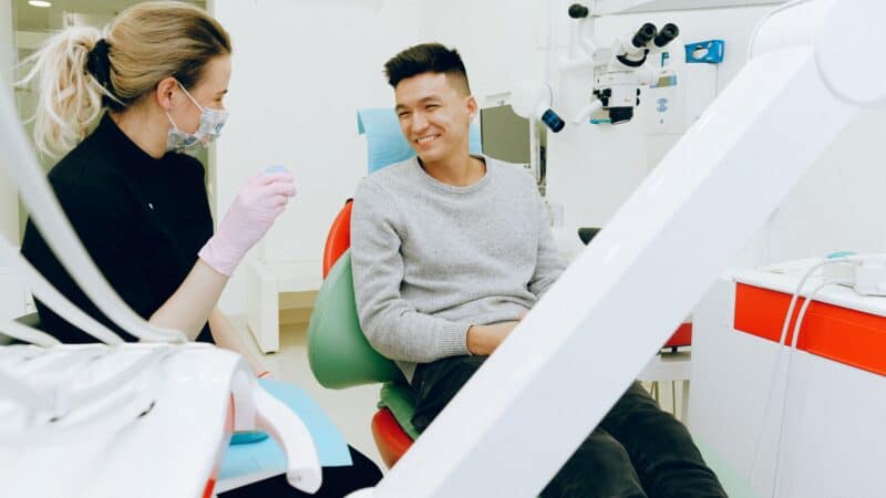 Person experiencing dental pain needing emergency care