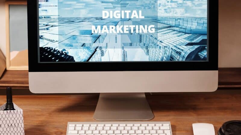 Dental practice owner writing blog content on laptop for content marketing